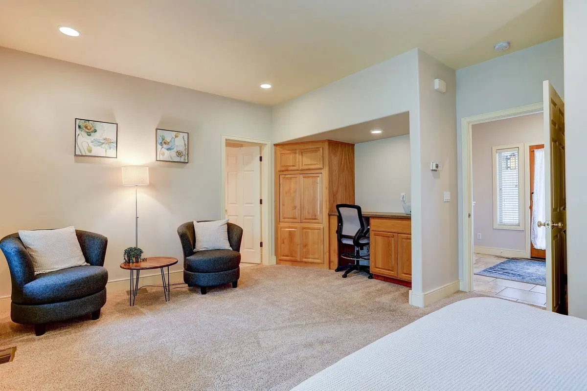 A cozy nook with two comfortable armchairs, a lamp, and a wooden desk—ideal spots for reading, relaxing, or working. The setting is both comfortable and versatile, inviting guests to unwind after a day outdoors or plan the next day's adventures.